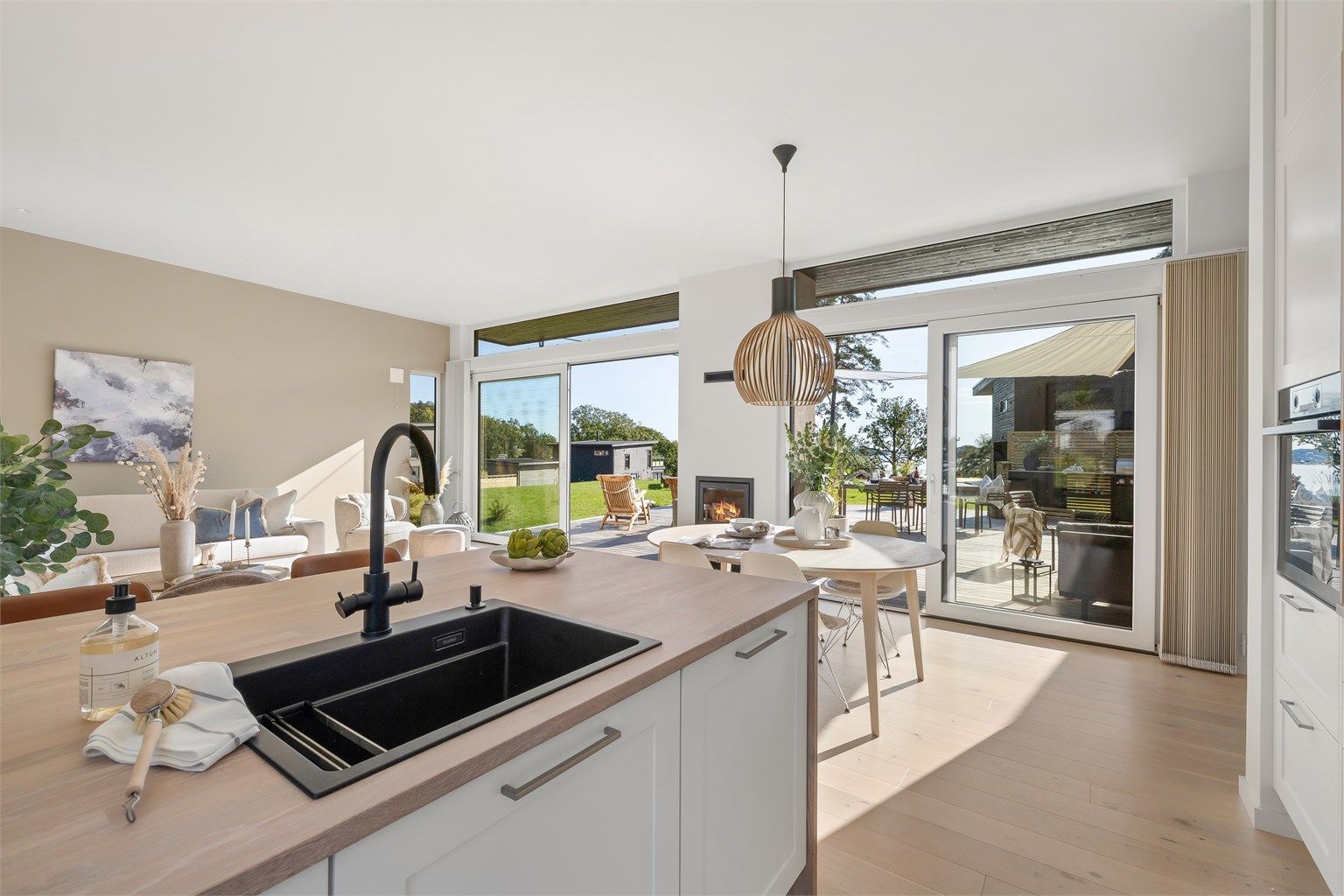 Fra kjøkkenet har du full oversikt over stuen og uteområdet.