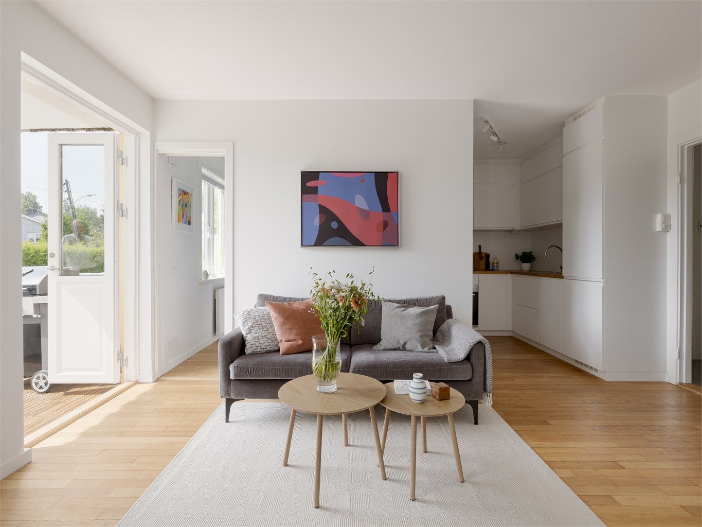 Med lyse overflater og et vakkert, originalt massivt tregulv av eik som er slipt og behandlet oppleves leiligheten både luftig og hjemmekoselig.