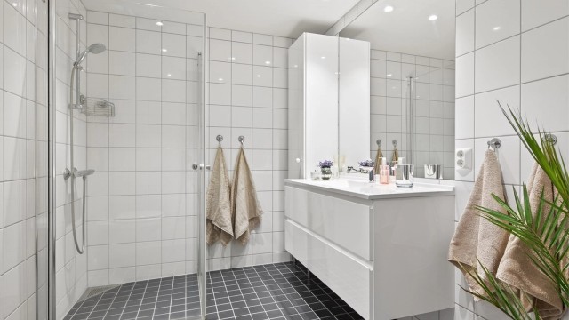 Pent flislagt bad med gulvvarme og downlights i himling.