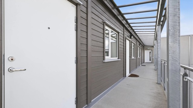 Svalgangen utenfor leiligheten har god plass og det er mulig å ha en liten sittegruppe utenfor døren sommerstid