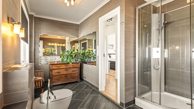 Badet er utstyrt med gulvvarme, dusjkabinett, vegghengt toalett og bidet.