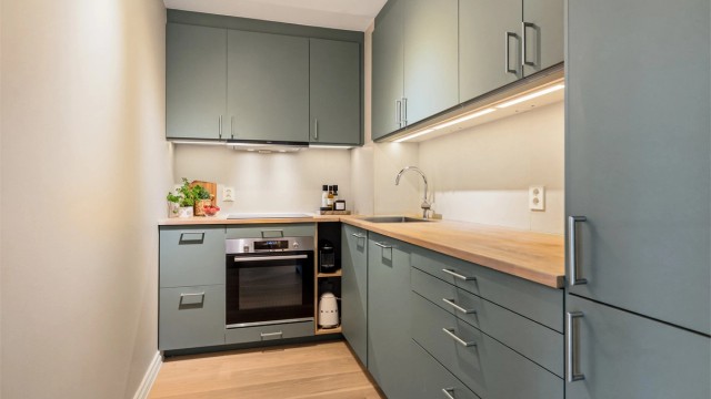 Moderne kjøkken fra 2020 med slette fronter, heltre benkeplate og rikelig med skap- og benkeplass. Foto: Trond Walsø / Walso Work