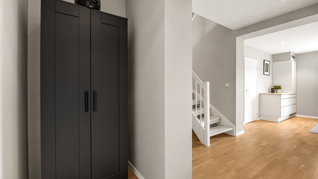 Hallen binder sammen rommene i 2. etasje og har en malt tretrapp som leder opp til loftstuen.
