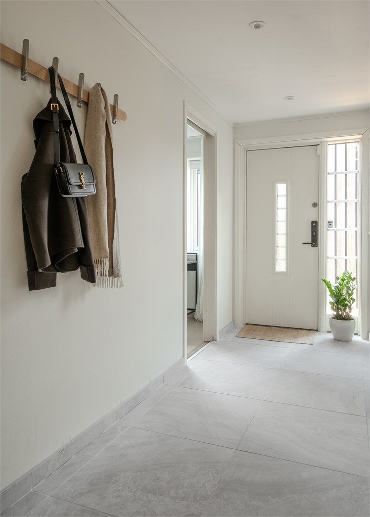 Entréen har flislagt gulv, malte vegger og nedsenket himling med integrerte downlights.