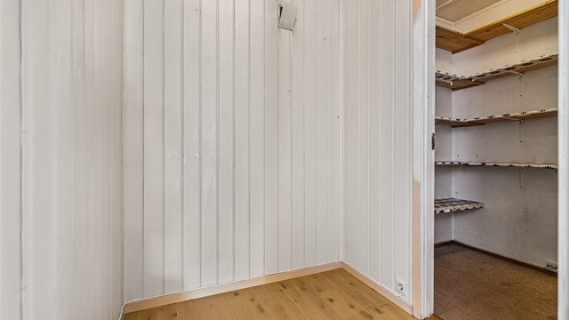 Praktisk innvendig bodrom med plassbygde hyller for oppbevaring.