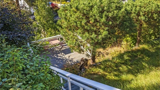Felles tomt i skrånende terreng med trappeadkomst ned til usjenert utsiktplatting.