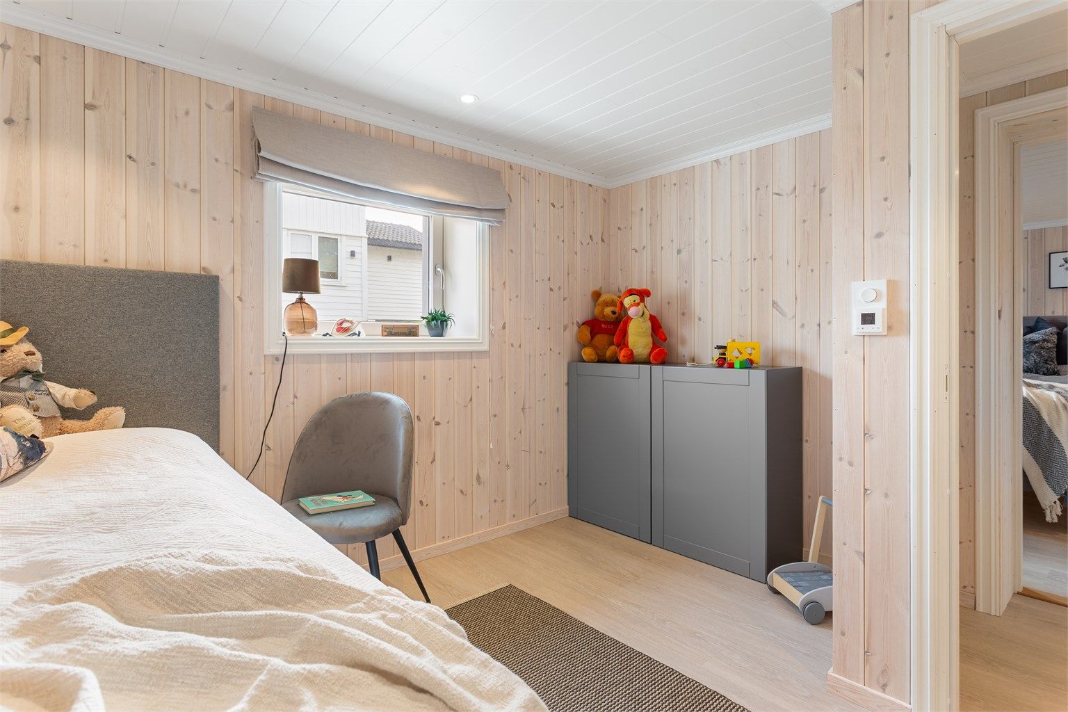 Det andre soverommet i etasjen har også lyst panel og plass til seng og oppbevaring. Ikke godkjent for varig opphold.