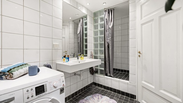 Badet er innredet med vegghengt servant med speil og stikkontakt på veggen over servanten. Det er opplegg for vaskemaskin.