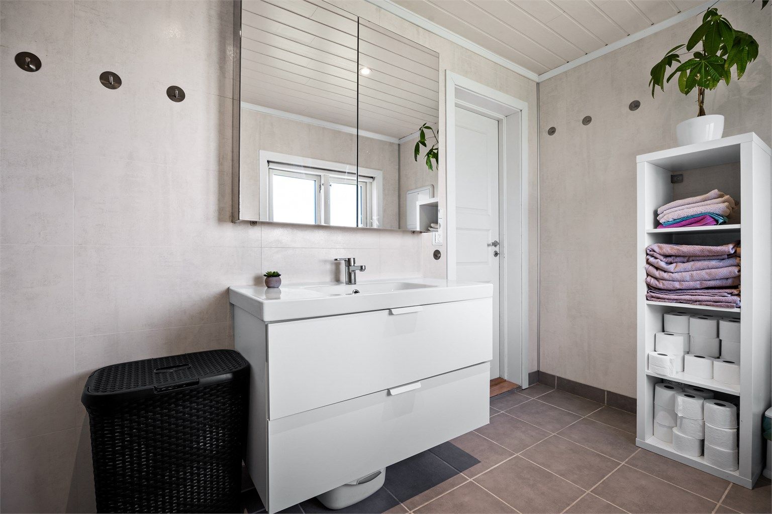 Badet har downlights i tak og varmekabler i gulv.