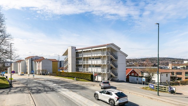 Herføllbakken rett utenfor bygget har et rolig gatetun-miljø og leder i retning gågaten.