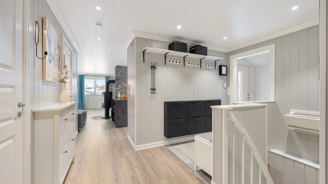 Fra gangen er det åpen tilgang til stue og kjøkken. En luft-til-luft-varmepumpe er plassert i trapperommet.