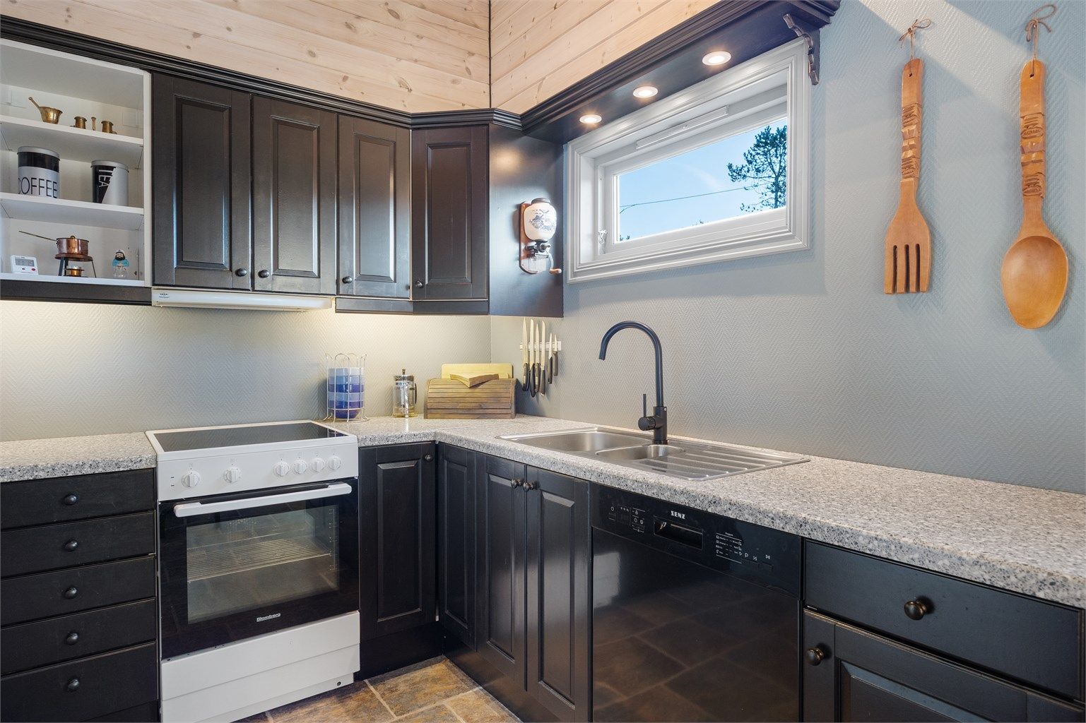 Pent hyttekjøkken med oppvaskmaskin samt god skap- og benkeplass