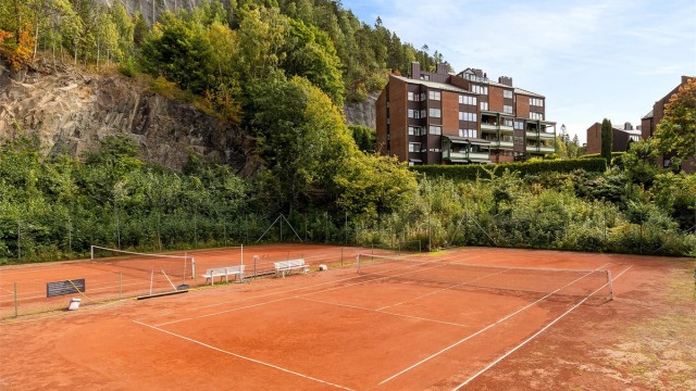 Tennisbanen på baksiden av bygget kan benyttes av seksjonseierene