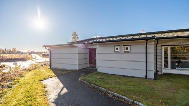 Asfaltert gangvei leder frem til leilighetens inngang.
