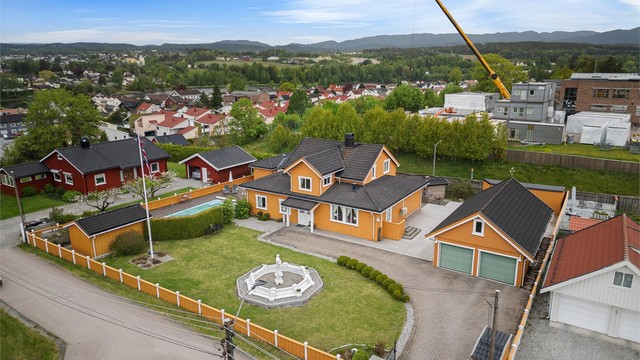 Pen eiendom omkranset av gjerde og støyskjerm mot Østre Brugate. Eiendommen ligger høyere enn veien og har derfor i tillegg naturlig skjerming.