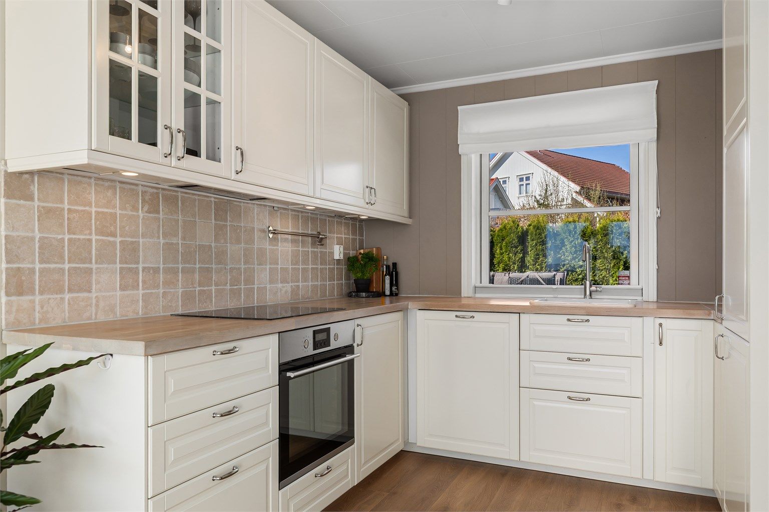 Lyst og pent kjøkken med integrerte hvitevarer 