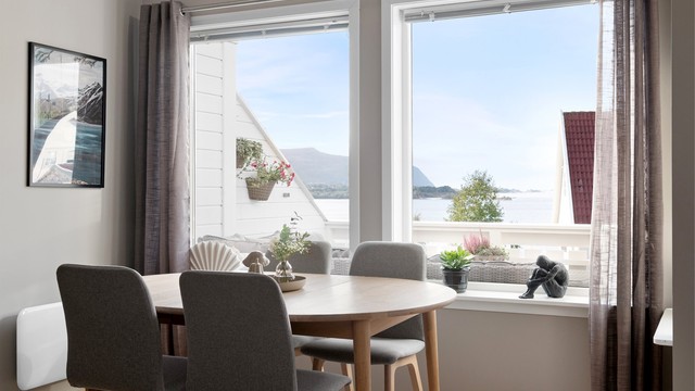 Spiseplassen er plassert ved vinduet med utsikt mot sjøen.