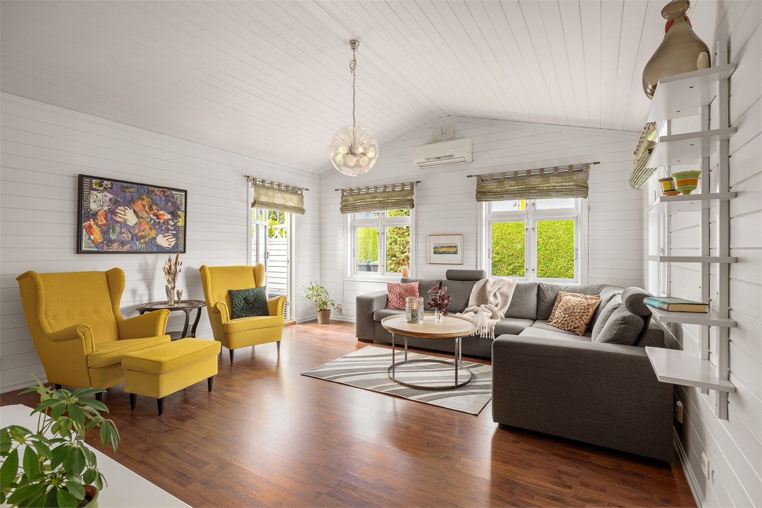 Stue med god takhøyde og utgang til hyggelig uteområde 
Foto: Eiendomsfoto AS