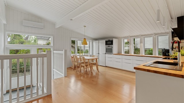 Kjøkkenrommet har god takhøyde og åpen forbindelse mot trappeløpet og utgang til hagen.