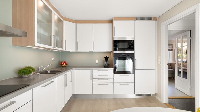Tidløst HTH-kjøkken fra 2010 med glatte fronter og laminat benkeplate.