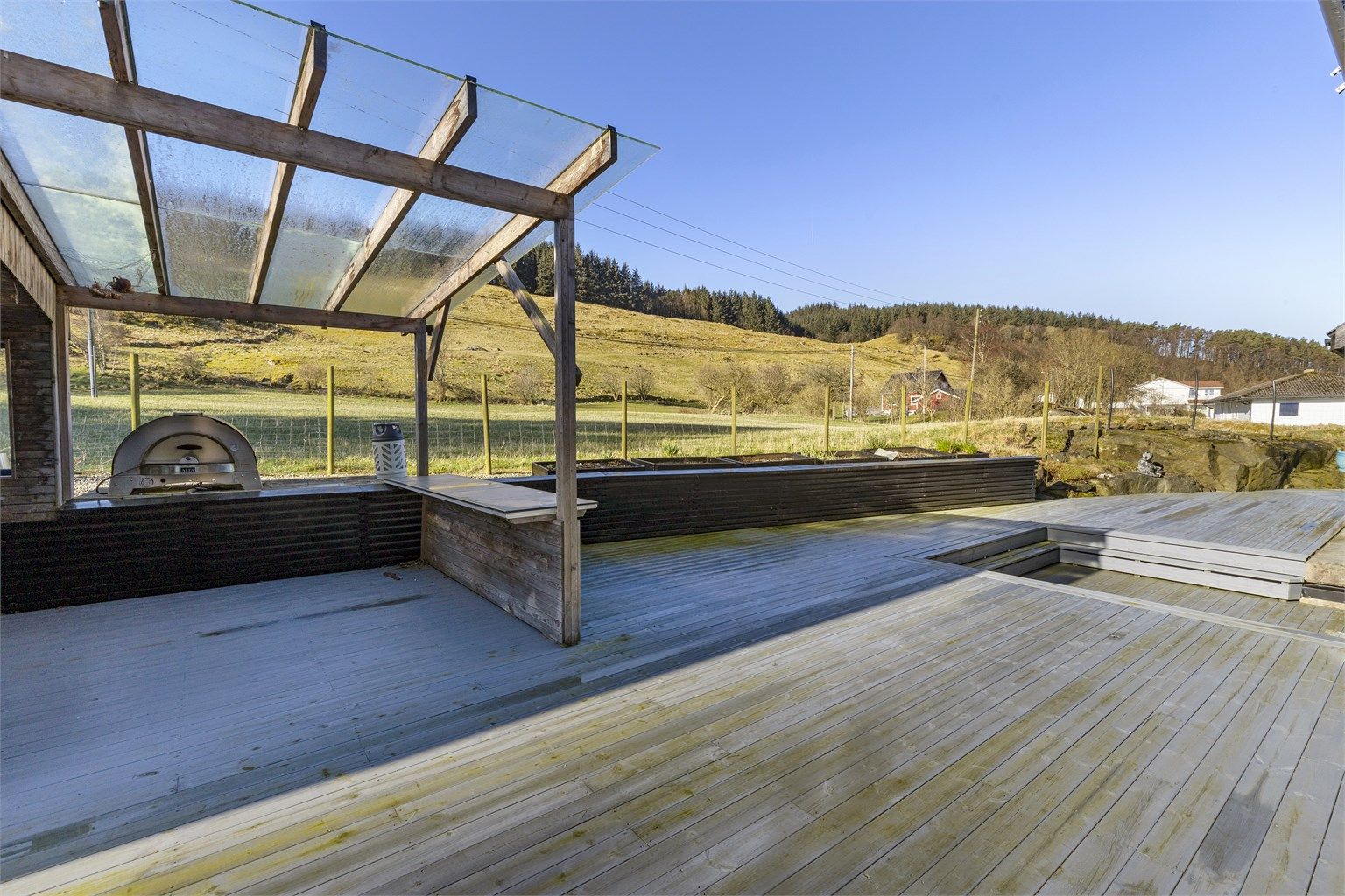 En del av uteplassen har en overbygget pergola, ideell for grilling og bespisning. Pizzaovn medfølger ikke. Pergola med tett tak er ikke omsøkt.