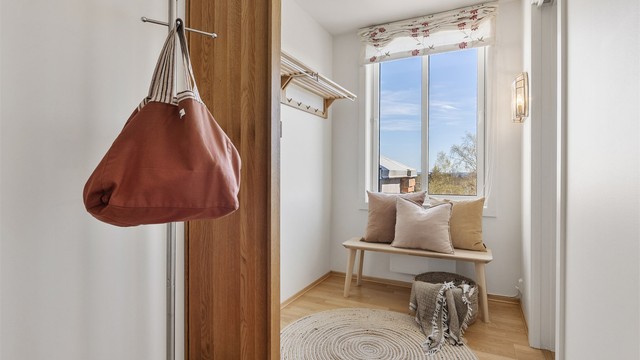 Stor entré med god plass til garderobeskap for oppbevaring av ytterklær og sko. Fra entreen er det tilgang til alle de andre rommene i leiligheten. I entreen er det en nisje med plass til skap eller hyllesystem, samt inngang til boden til høyre på bildet.