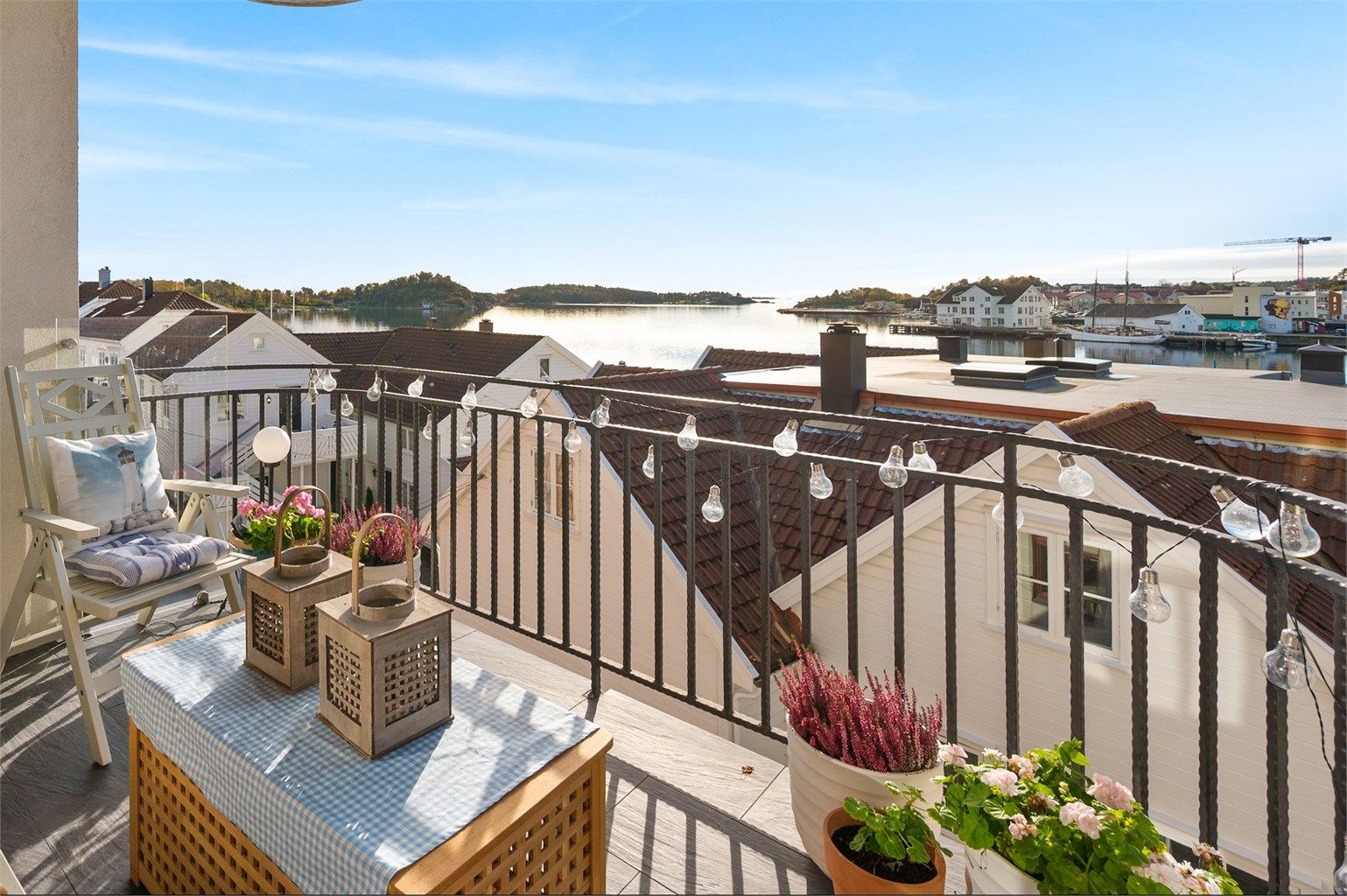 Koselig og solrik veranda med utsikt mot havet.