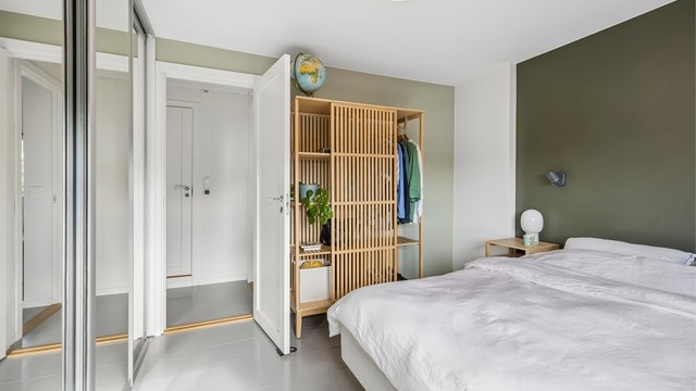 Gode oppbevaringsmuligheter i en romslig skyvedørsgarderobe, i tillegg til ekstra lagringsplass i frittstående skap.