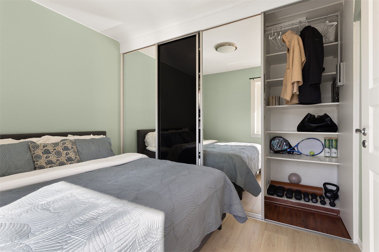 En stor skyvedørsgarderobe med speilfronter gir rikelig med oppbevaringsplass.