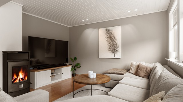 Lun sofakrok ved peisovnen med innfelte downlights i himlingen.