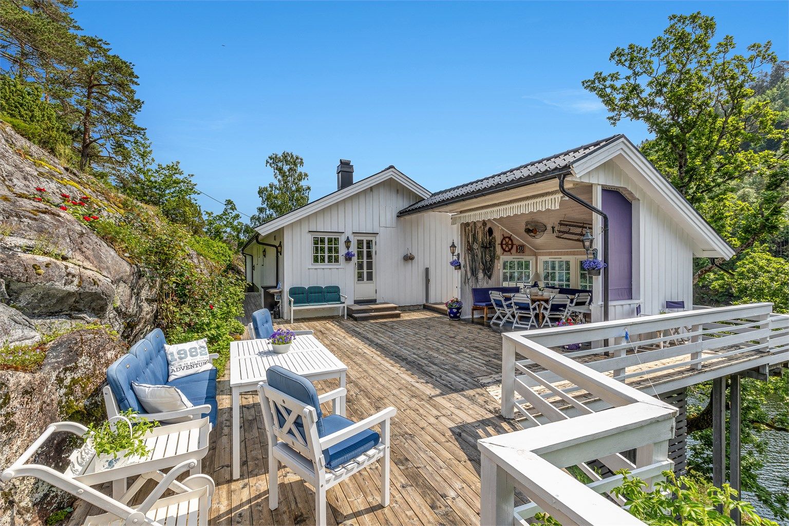 På sørvestre hjørne av terrassen er det spiseplass med overbygg, som gir verdifull skygge på varme sommerdager og bidrar til en lun uteplass på sene sommerkvelder.