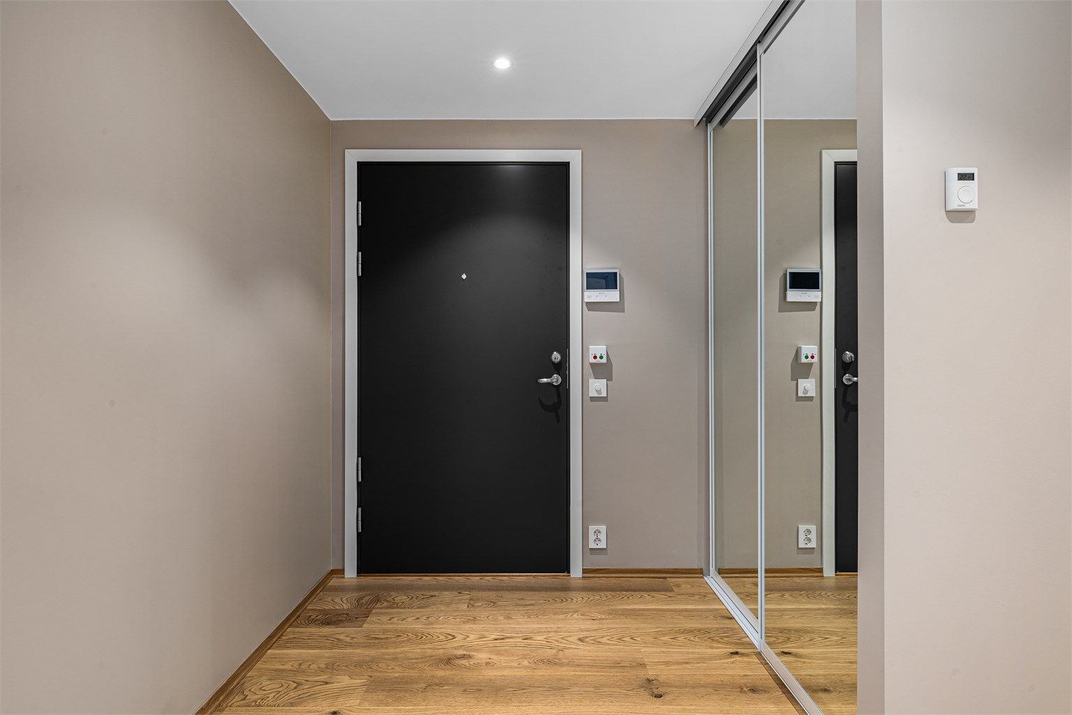 Inngangsdør. Callinganlegg med kamera. Romslig skyvedørsgarderobe.