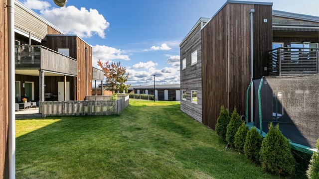 Utsyn fra terrassen til sameiets velstelte grøntarealer. Sameiet består av 42 boligseksjoner.