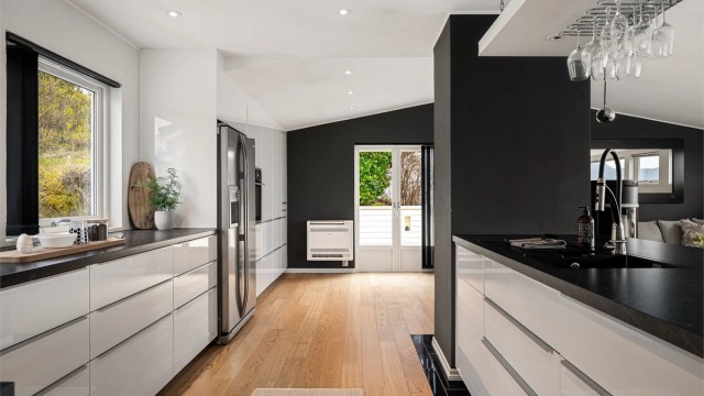 Stilrent og meget innholdsrikt kjøkken fra Ikea med integrerte hvitevarer. Det er varme i kjøkkengulvet.