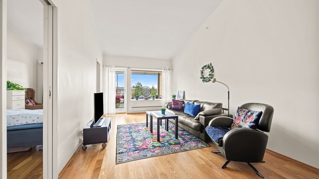 Stuen har god plass til sofagruppe og utgang til den overbygde balkongen.