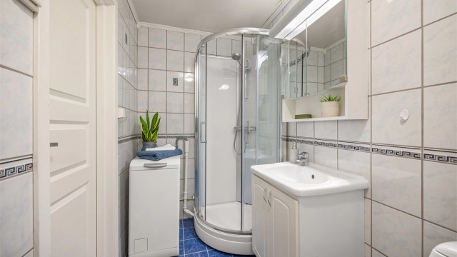 Badet har dusjkabinett og opplegg for vaskemaskin. Vaskemaskin medfølger.