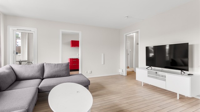 Lys stue med sofaområde.