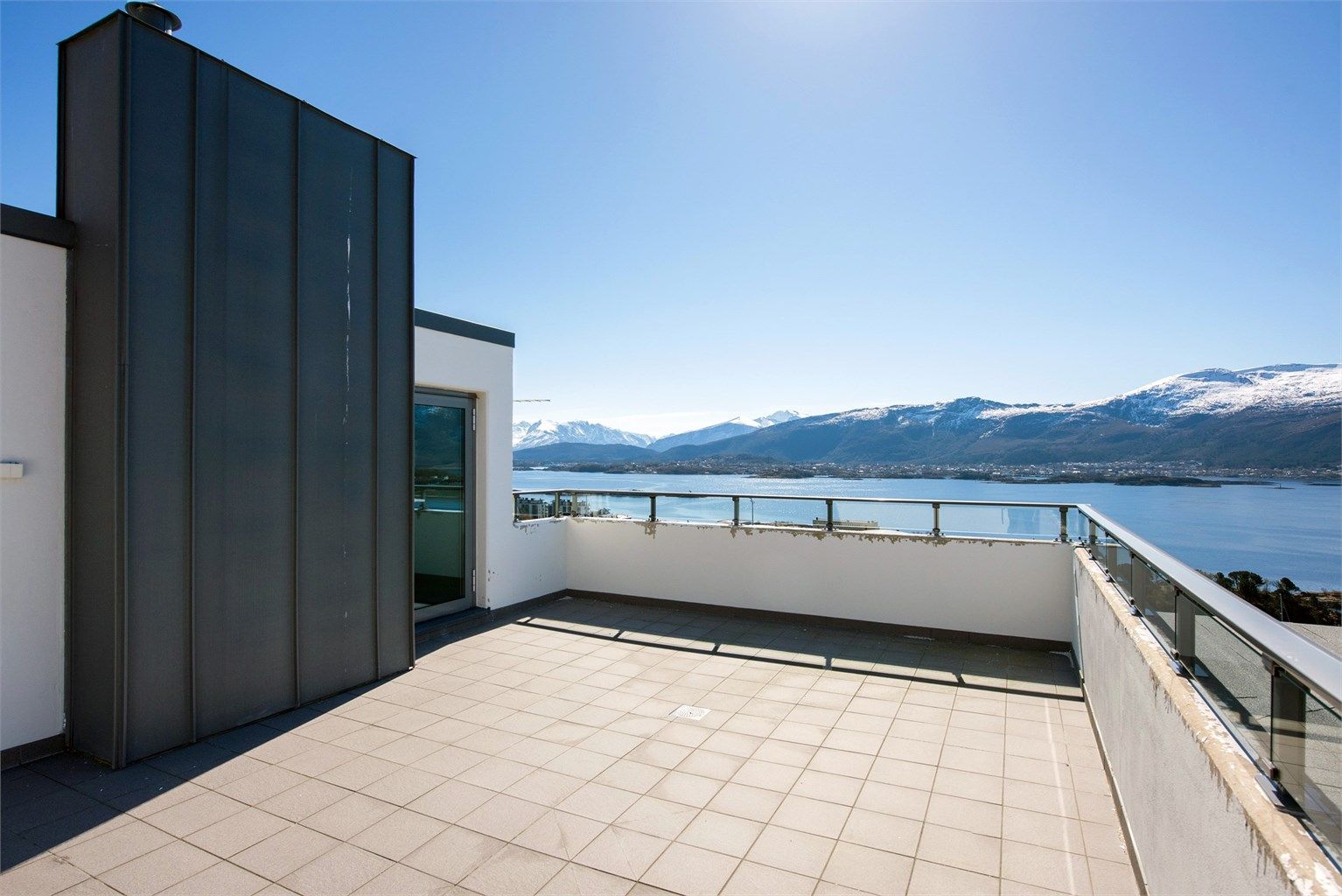 Felles takterrasse med praktfull utsikt mot by, fjord og fjell