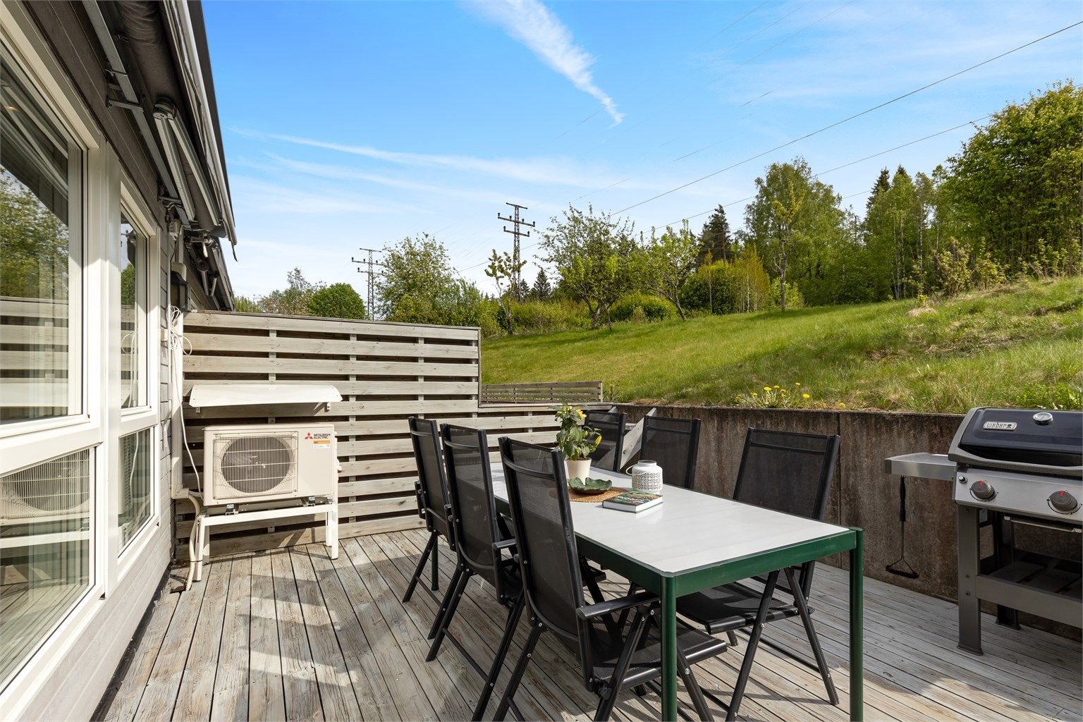 På denne siden av rekkehuset får man flotte grøntarealer og hage. Terrasseplattingen er av god størrelse med plass til å møblere med ønsket utemøblement.