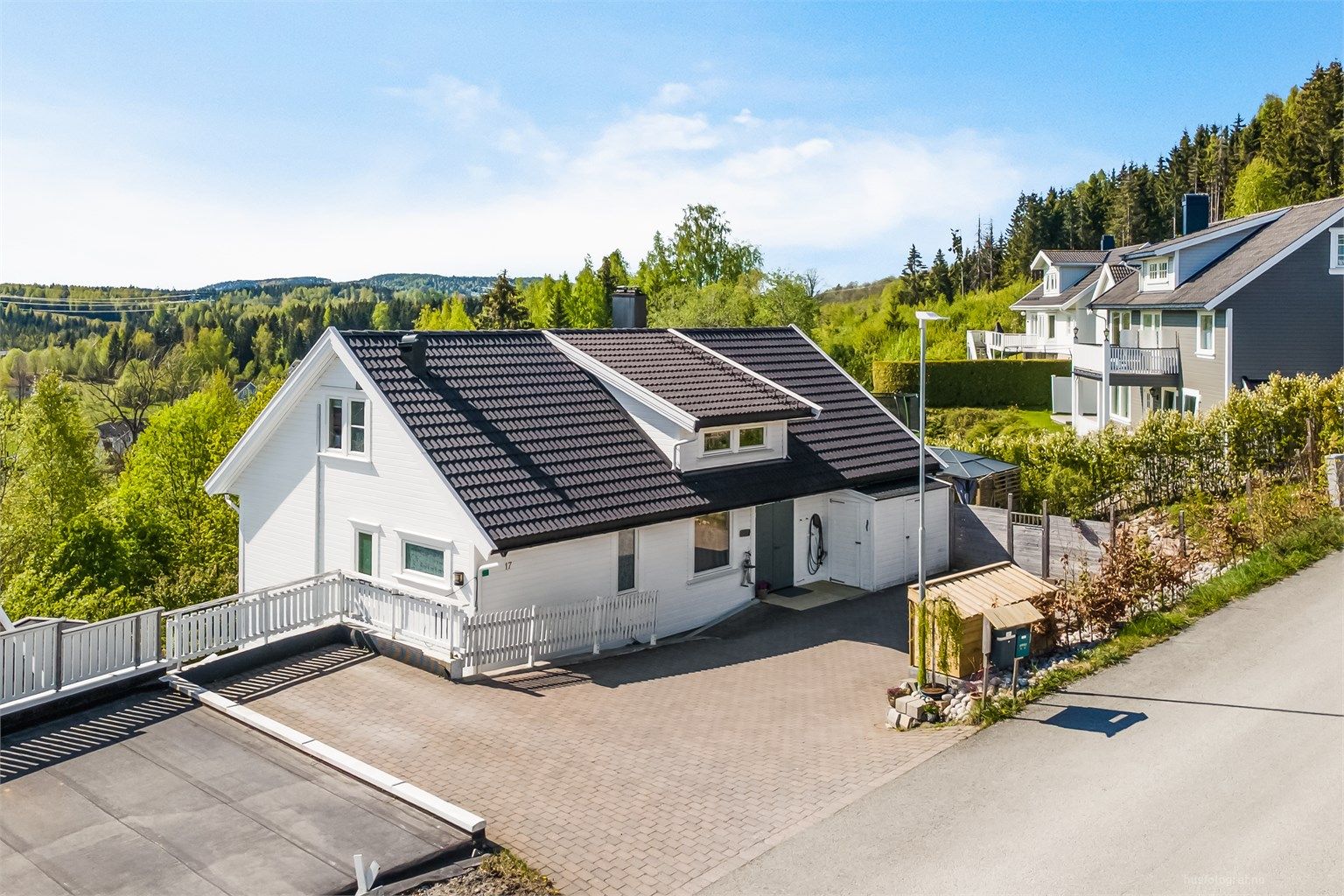 Romslig gårdsplass med el-billader (2021) på husveggen