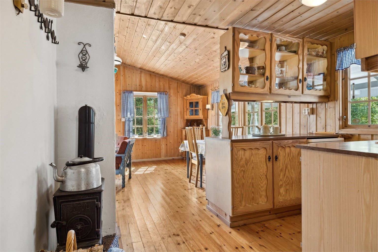 Lunt kjøkken med åpen løsning mot stue.