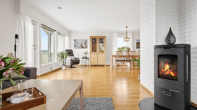Den romslige vinkelstuen har en peisovn med glassdør som gir god varme.