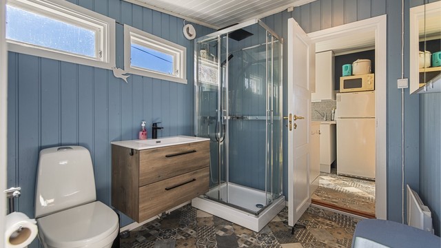 Rommet har malt trepanel på vegger og i himling. Gulv har belegg.