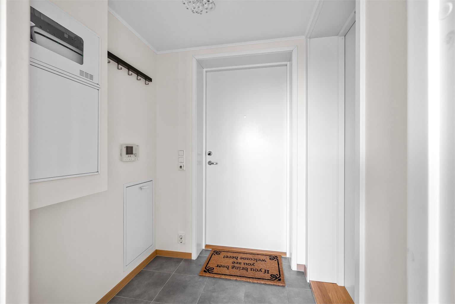 Lys og praktisk entré med flislagt gulv med varme.