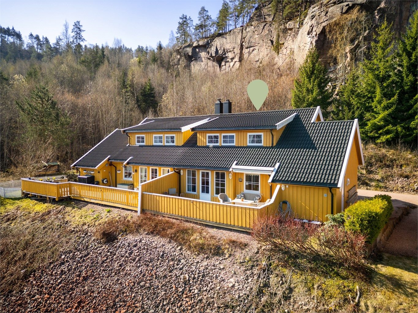 Tomten er opparbeidet med noe gressplen med diverse beplantninger og gruset gårdsplass.