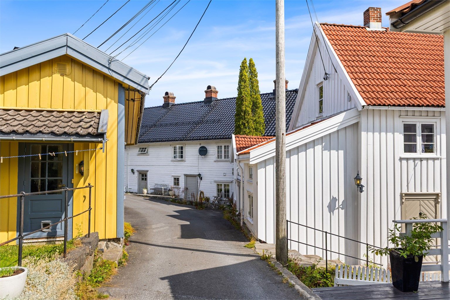 Gatemiljøet preges av tradisjonell trehusbebyggelse med frodige hager og beplantning.