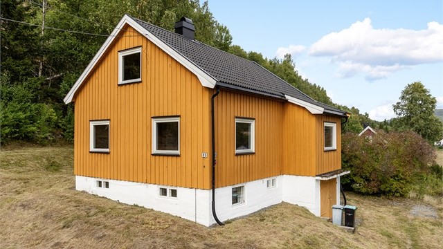 Yttervegger kledd med stående trepanel og yttertak tekket med takstein fra ca. 2015.