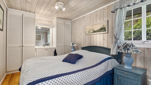 Lyst hovedsoverom med servant og garderobeskap.