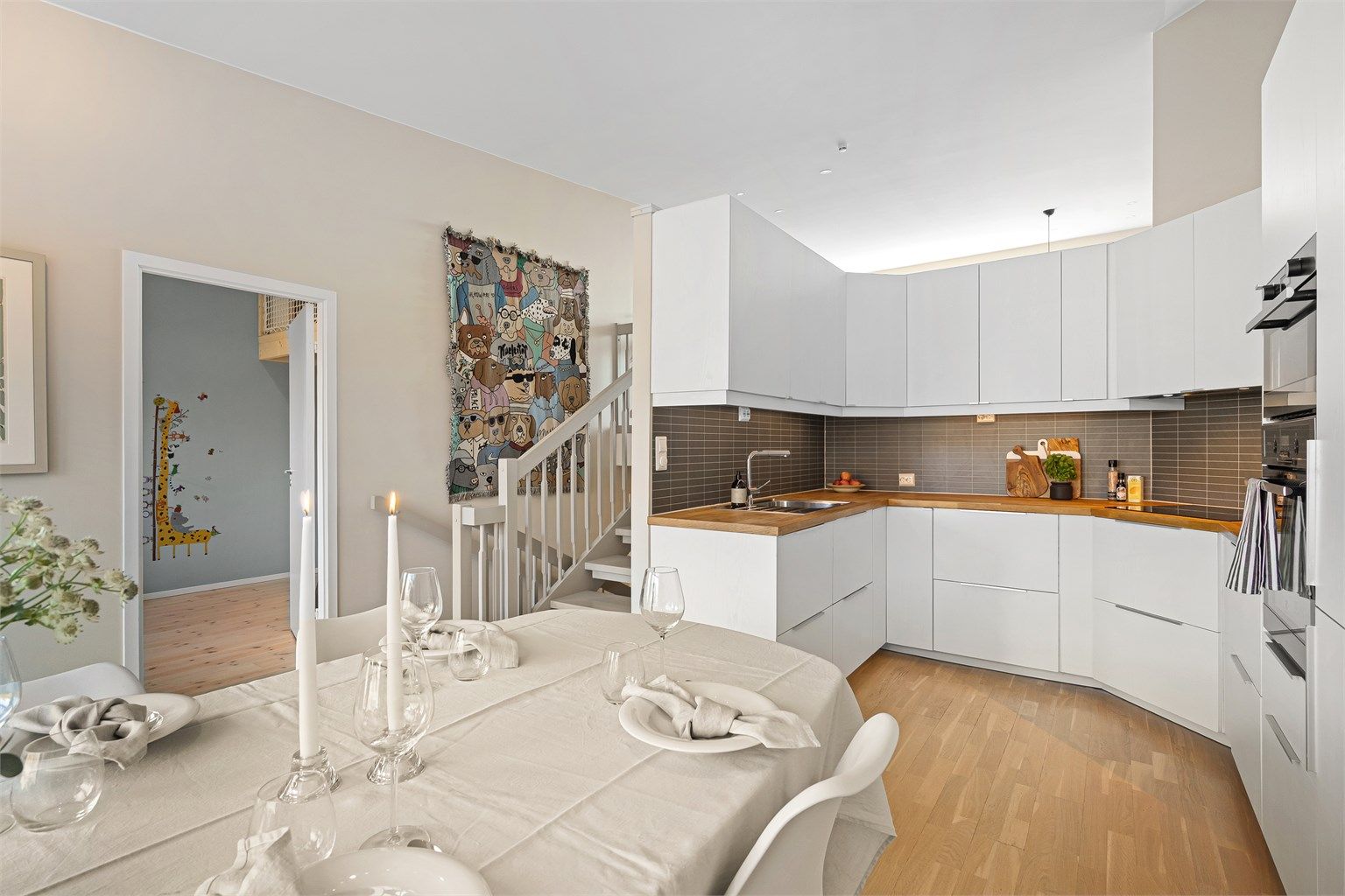 Lys og romslig spisestue med god plass til stort spisebord, praktisk plassert ved kjøkkenet.