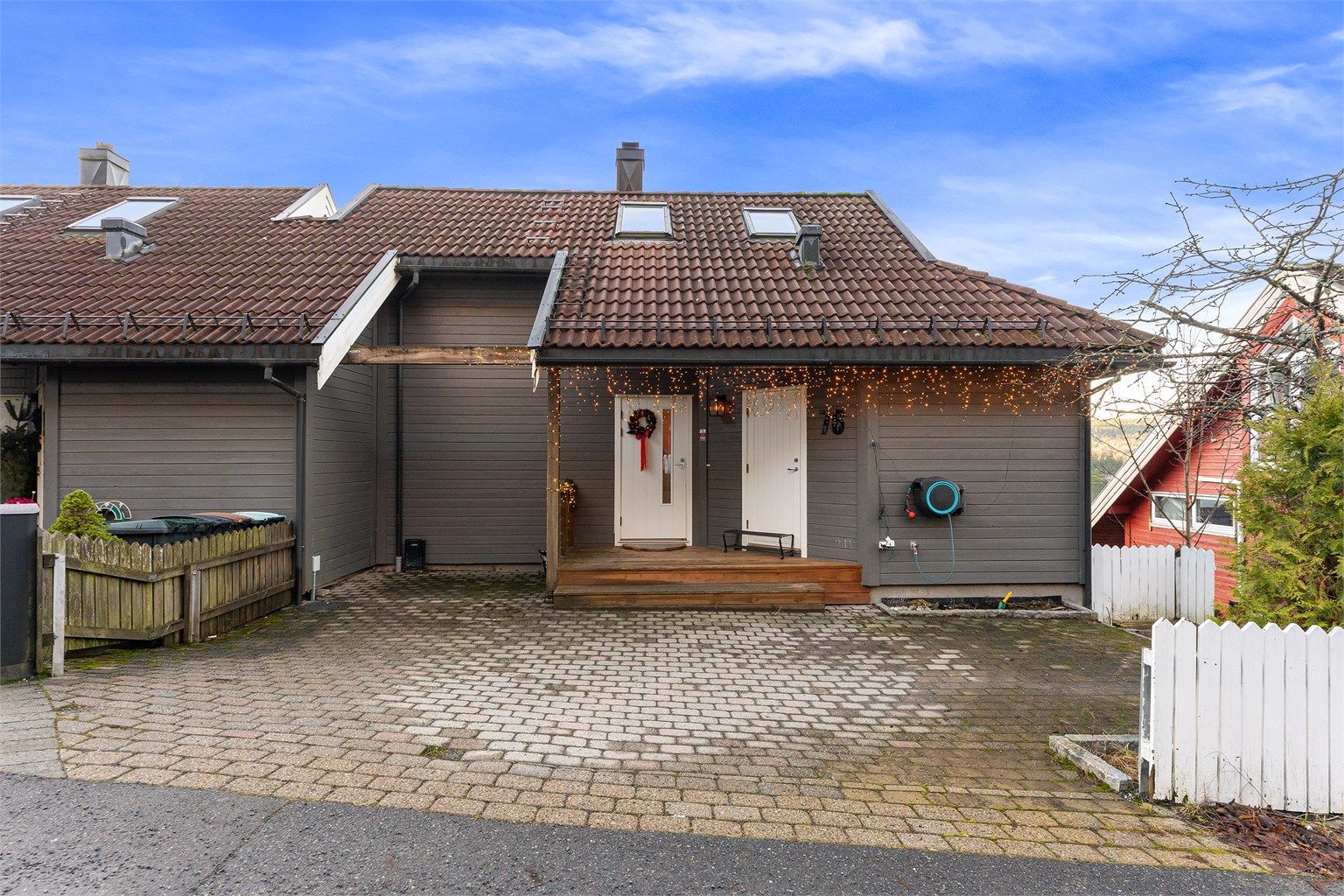 Huset har parkering i garasje og parkeringsmulighet foran huset. Til høyre for inngangsdøren er det en praktisk bod med god largringsplass